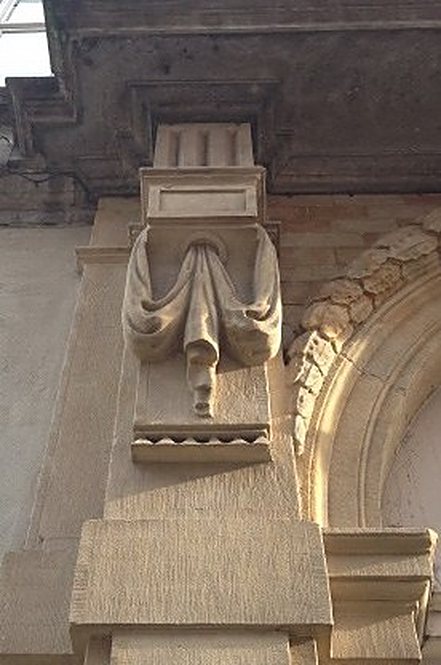 Carved stone console on a historic facade
