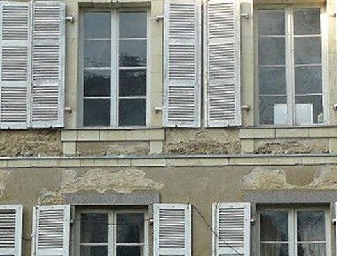 Historic facade with wooden shutters